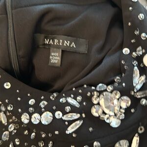 Formal black gown with open shoulders.